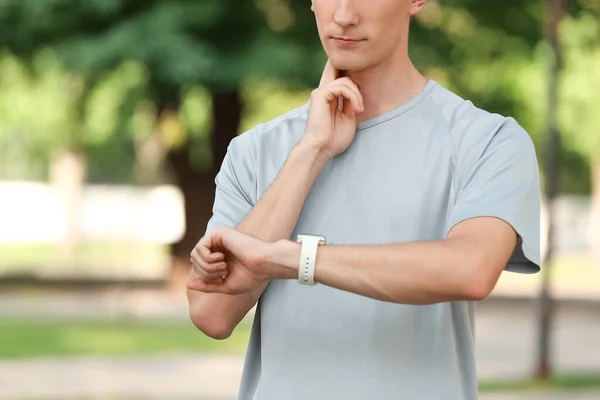 Sporty Male Runner Checking Pulse Outdoors — Stock Photo, Image
