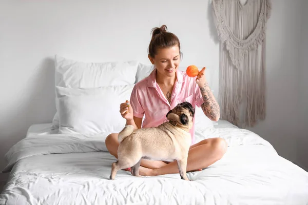 Young Woman Playing Cute Pug Dog Bedroom — Stock Photo, Image