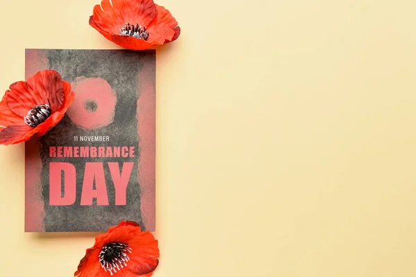 Remembrance Day in Canada. Red poppy flowers with card on beige background