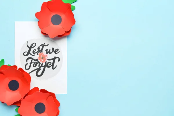 Remembrance Day in Canada. Red poppy flowers with card on blue background