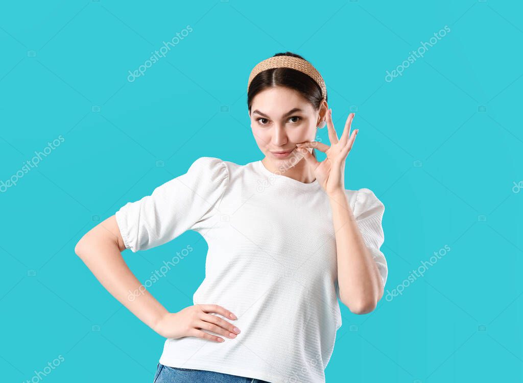 Young gossip woman zipping her mouth on blue background