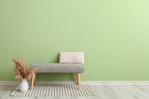 Interior of stylish modern room with banquette near color wall