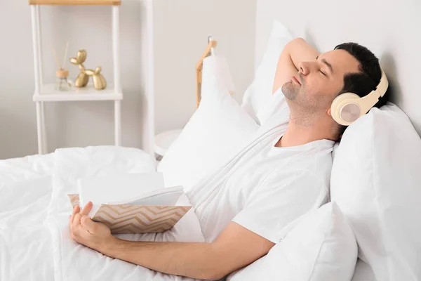 Young Man Book Listening Music Bedroom — Stock Photo, Image