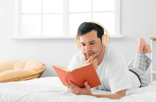 Jeune Homme Lisant Livre Écoutant Musique Dans Chambre — Photo