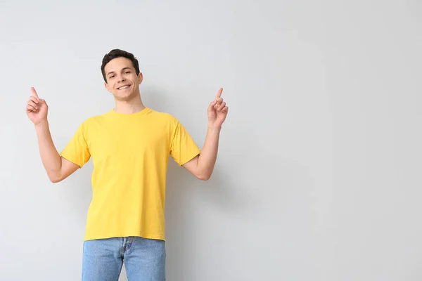 Handsome Young Man Stylish Shirt Pointing Something Light Background — Stock Photo, Image