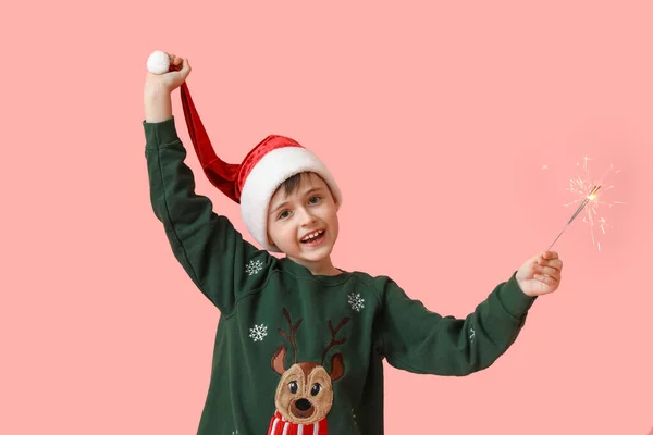 Kleiner Junge Mit Weihnachtsmütze Und Wunderkerzen Auf Farbigem Hintergrund — Stockfoto