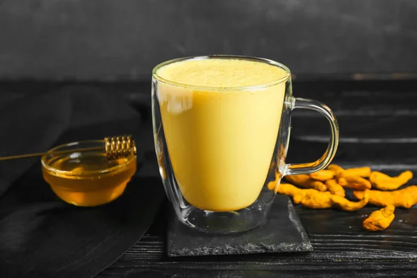 Glass Cup Healthy Turmeric Latte Honey Dark Wooden Table Closeup — Stock Photo, Image