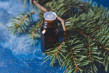 Renkli arka planda bir şişe kozalaklı gerekli yağ