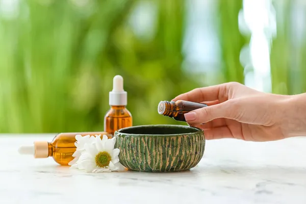 Woman Adding Essential Oil Water Bowl Table — Stock Photo, Image