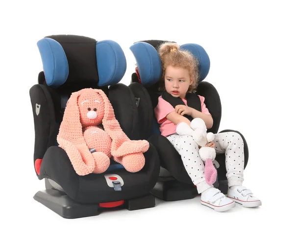 Cute Little Girl Toys Buckled Car Safety Seat White Background — Stock Photo, Image