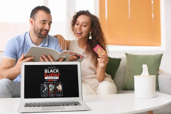 Couple shopping online on Black Friday at home