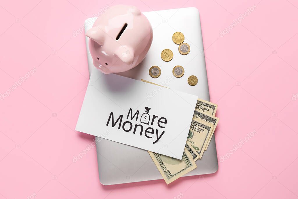 Paper sheet with text MORE MONEY, laptop and piggy bank on color background. New year goals