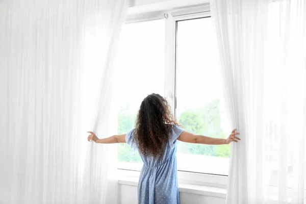 Young African American Woman Opening Light Curtains Home Morning — Stock Photo, Image