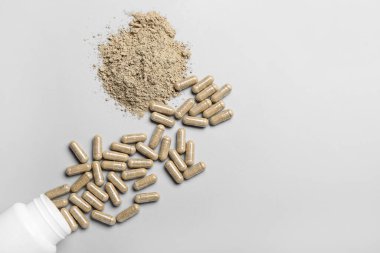 Şişede haplar ve arka planda barut.