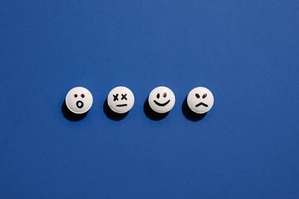 Pastillas Con Caras Dibujadas Sobre Fondo Azul — Foto de Stock