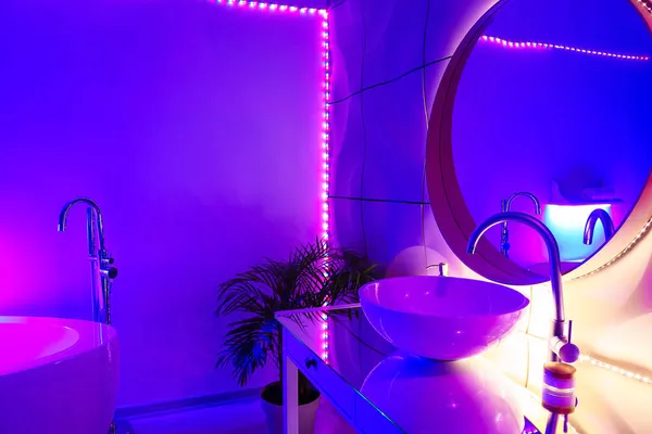 Interior of stylish bathroom with neon lighting