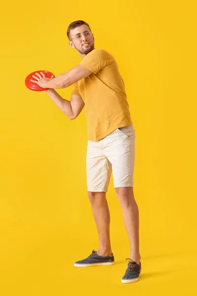 Handsome Young Man Throwing Frisbee Yellow Background — Stock Photo, Image