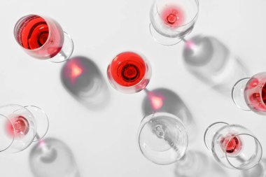 Açık arkaplanda kırmızı şarap artığı olan bardaklar