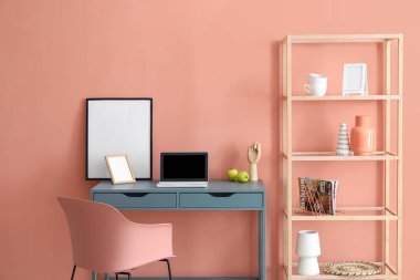 Renkli duvarın yanında modern işyeri olan şık bir oda.