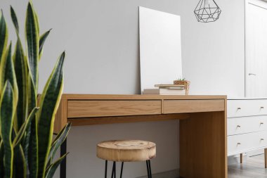 Modern ahşap masa, oturma odasında ışık duvarının yanında dekor var.