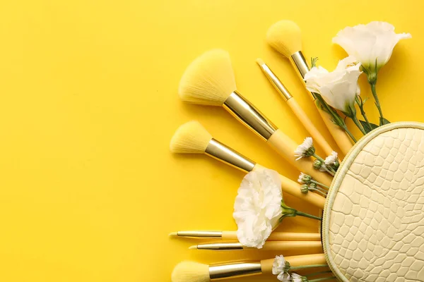 Cosmetic Bag Stylish Makeup Brushes Flowers Yellow Background — Stock Photo, Image