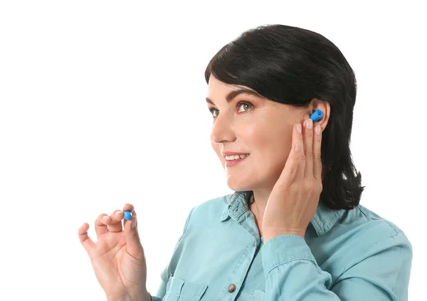 Mature Woman Putting Blue Ear Plugs White Background — Stock Photo, Image