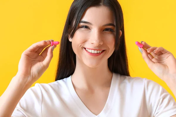 Pretty Young Woman Pink Ear Plugs Yellow Background — Stock Photo, Image