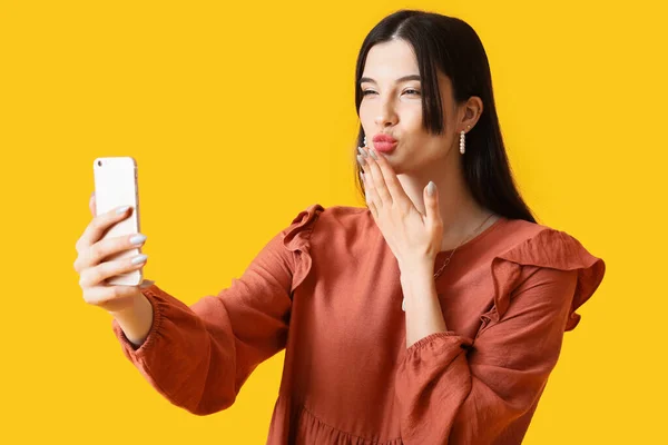 Pretty Young Woman Taking Selfie Blowing Kiss Yellow Background — Stock Photo, Image