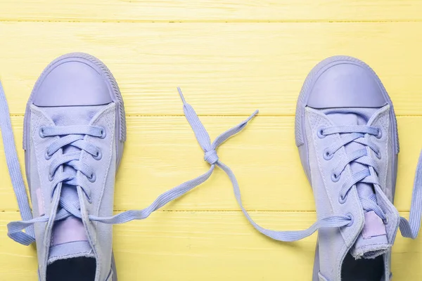 Pair Shoes Laces Tied Knot Color Wooden Background Closeup — Stock Photo, Image