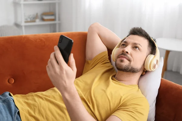 Man Phone Headphones Lying Sofa — Stock Photo, Image