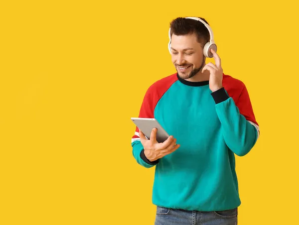 Άντρας Tablet Υπολογιστή Και Ακουστικά Στο Φόντο Χρώμα — Φωτογραφία Αρχείου