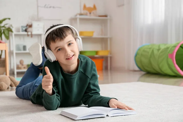 Little Boy Book Headphones Showing Thumb Home — Stock Photo, Image