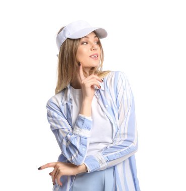 Yüzüne yakın işaret parmağı olan güzel bir kadın beyaz arka planda güneşlik şapka takıyor.