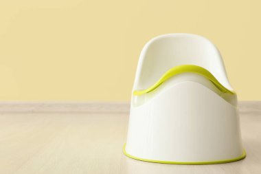 Ahşap zeminde, renkli duvarın yanında.