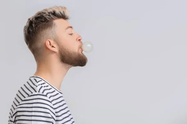 Young Man Chewing Gum Light Background — Stock Photo, Image