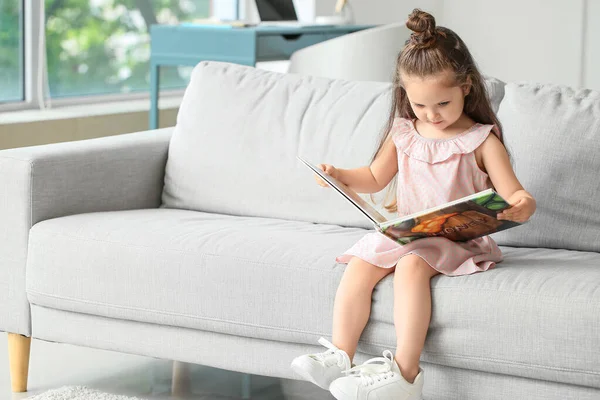 Adorable Little Girl Reading Book Sofa Home — Stock Photo, Image