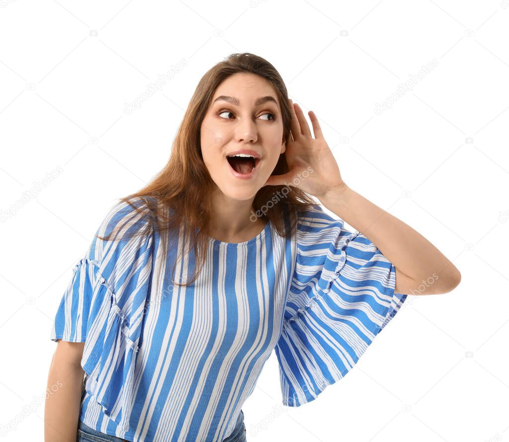 Young gossip woman trying to hear something on white background