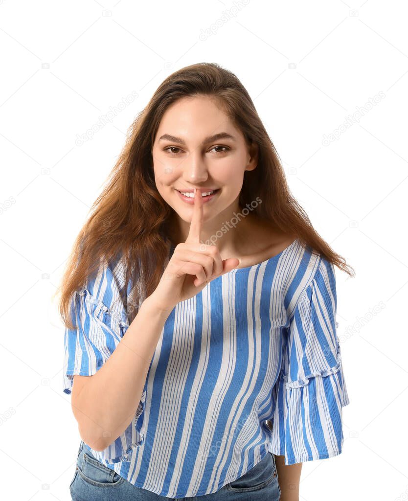 Young gossip woman showing silence gesture on white background