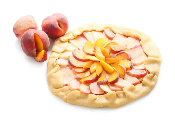 Raw peach galette on white background