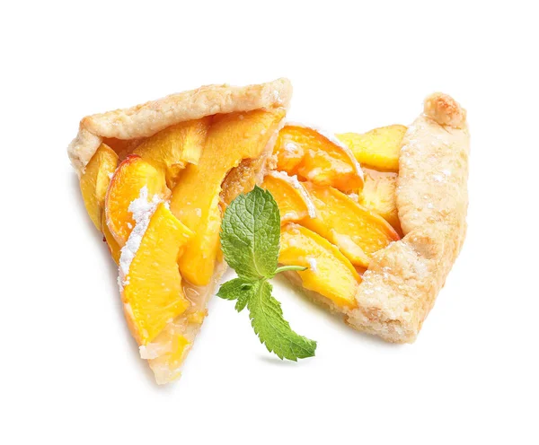 Pieces of tasty peach galette on white background