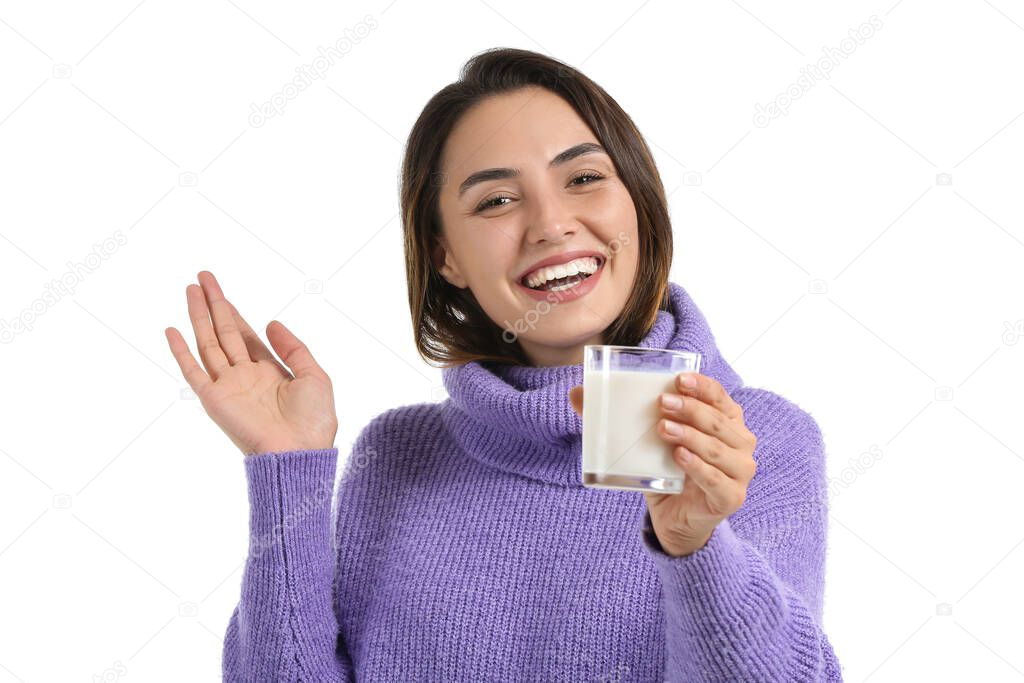 Young woman with glass of fresh milk on white background