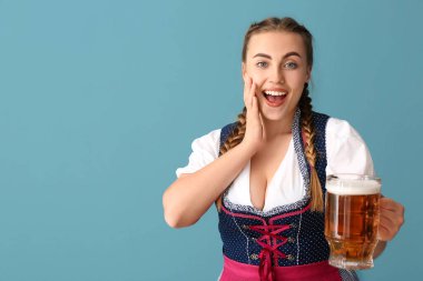 Şaşırdım genç Ekim Festivali garsonu. Mavi arka planda birası var.