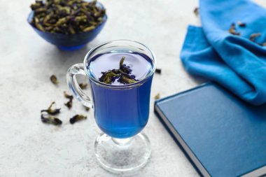 Hafif arkaplanda bir bardak mavi çay.