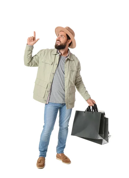 英俊的男人 黑色星期五购物袋指着白色背景的东西 — 图库照片