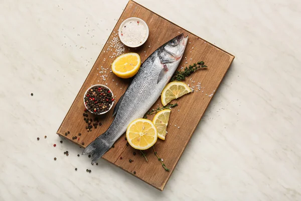 Wooden Board Fresh Uncooked Sea Bass Fish Lemon Spices White — Stock Photo, Image