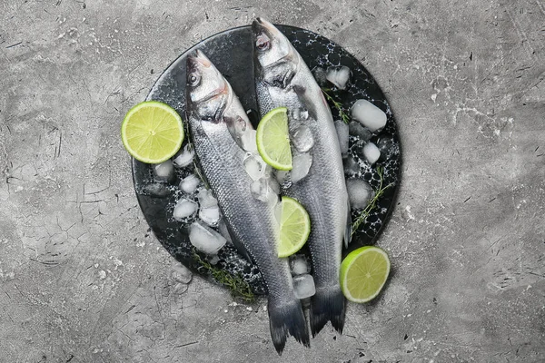 Board Fresh Uncooked Sea Bass Fish Lemon Grunge Background — Stock Photo, Image