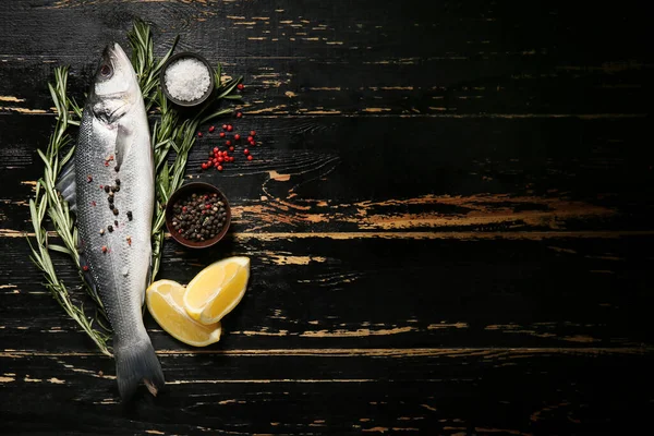 Fresh Uncooked Sea Bass Fish Lemon Spices Black Wooden Background — Stock Photo, Image