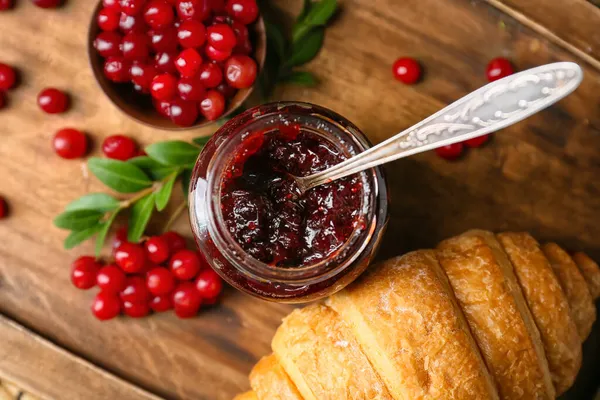 Jar Tasty Lingonberry Jam Berries Croissant Wooden Background — Stock Photo, Image