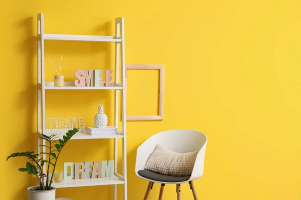 Stylish Shelf Unit Decor Houseplant Chair Yellow Wall Closeup — Stock Photo, Image