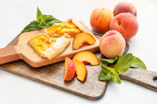 Board Pieces Tasty Peach Galette Light Background — Stock Photo, Image